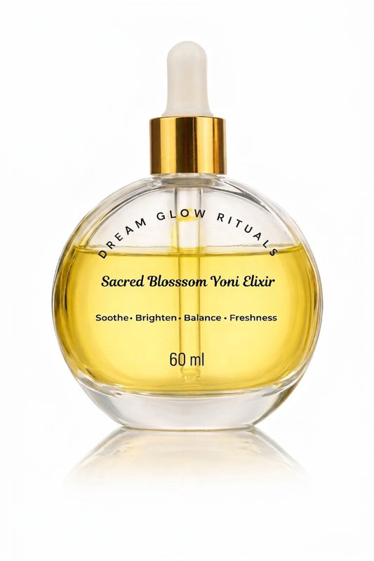 A 60 ml glass dropper bottle of Sacred Blossom Voni Elixir by Dream Glow Rituals, filled with golden-yellow liquid and featuring a gold collar and white dropper cap, set against a clean white background with a soft reflection.