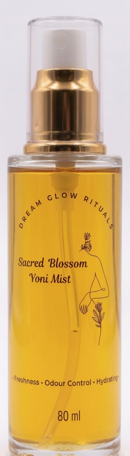 A 80 ml glass spray bottle of Dream Glow Rituals Sacred Blossom Voni Mist, filled with golden-yellow liquid and featuring a gold pump and white cap, set against a plain white background.
