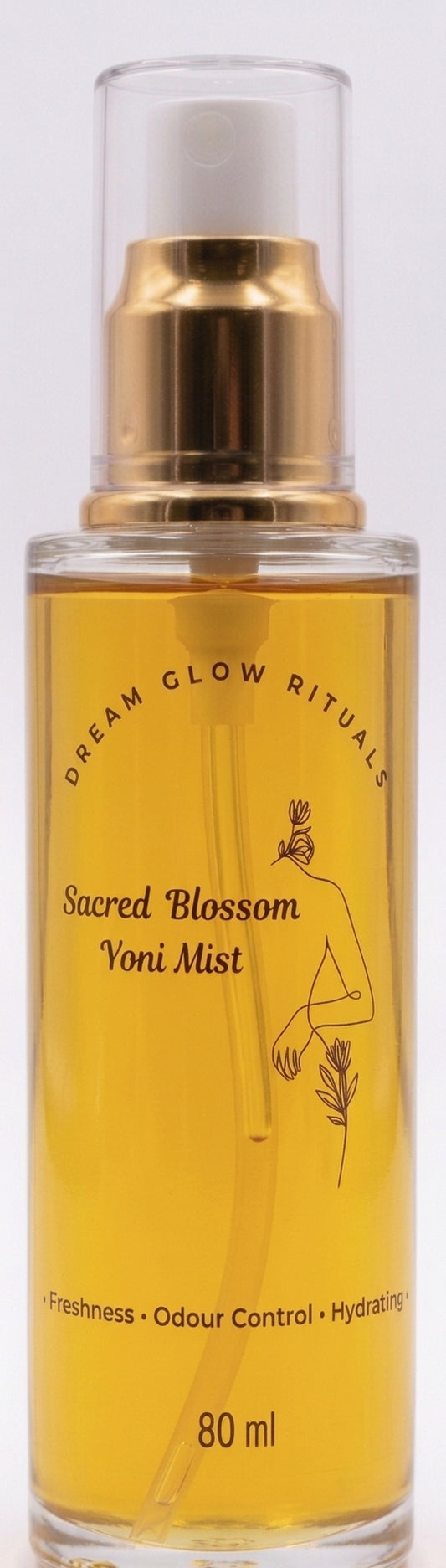 A 80 ml glass spray bottle of Dream Glow Rituals Sacred Blossom Voni Mist, filled with golden-yellow liquid and featuring a gold pump and white cap, set against a plain white background.