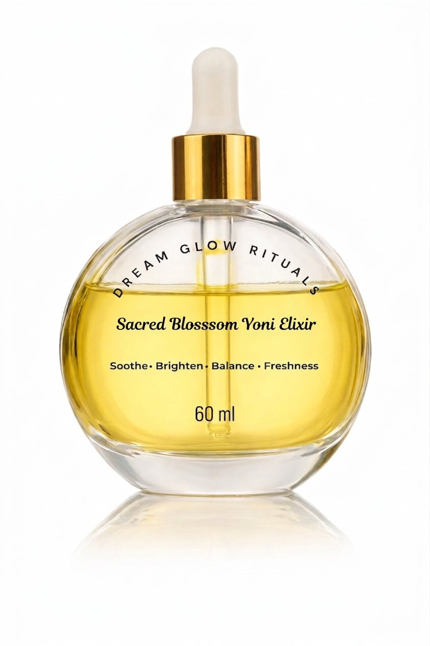 A 60 ml glass dropper bottle of Sacred Blossom Voni Elixir by Dream Glow Rituals, filled with golden-yellow liquid and featuring a gold collar and white dropper cap, set against a clean white background with a soft reflection.